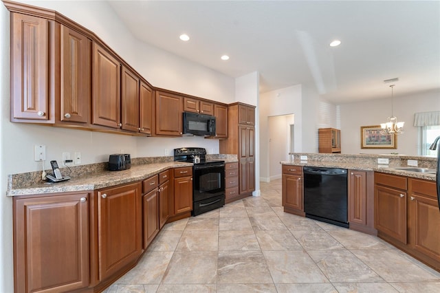 kitchen featuring decorative light fixtures, a notable chandelier, black appliances, sink, and light stone counters