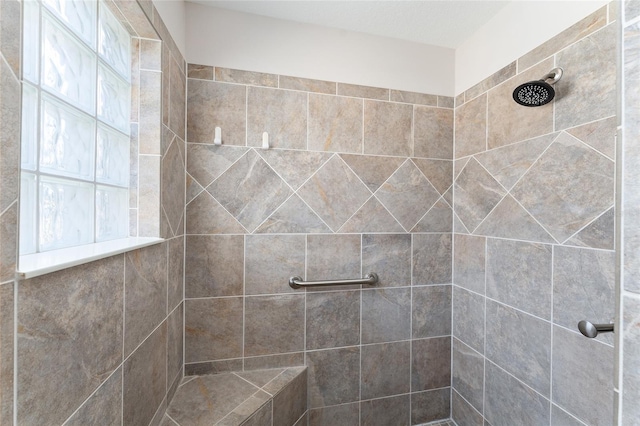 bathroom with tiled shower