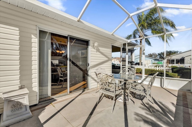 view of patio featuring a lanai