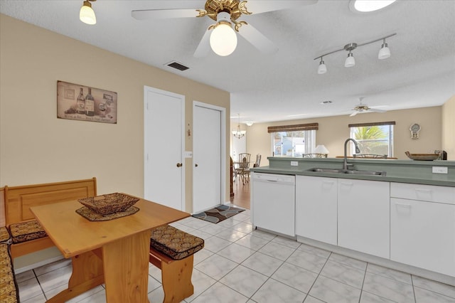 kitchen featuring a textured ceiling, ceiling fan, sink, dishwasher, and white cabinets