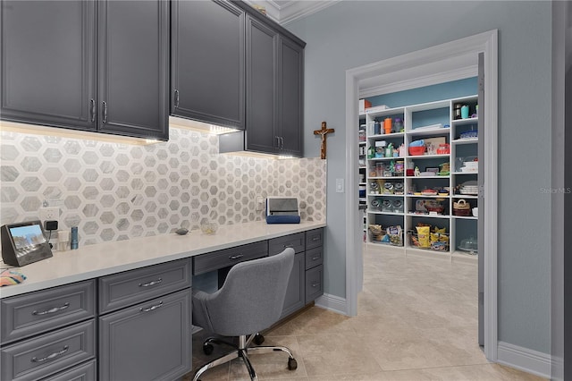 office area featuring crown molding and built in desk