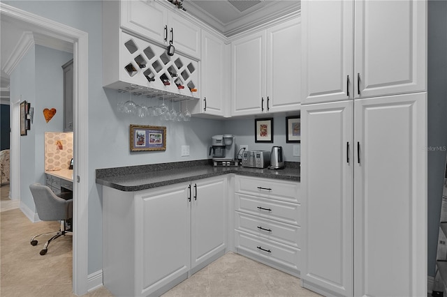 kitchen featuring white cabinets and light tile patterned flooring