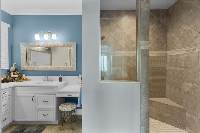 bathroom with crown molding, tiled shower, and vanity