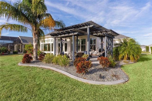 rear view of house featuring a pergola and a lawn