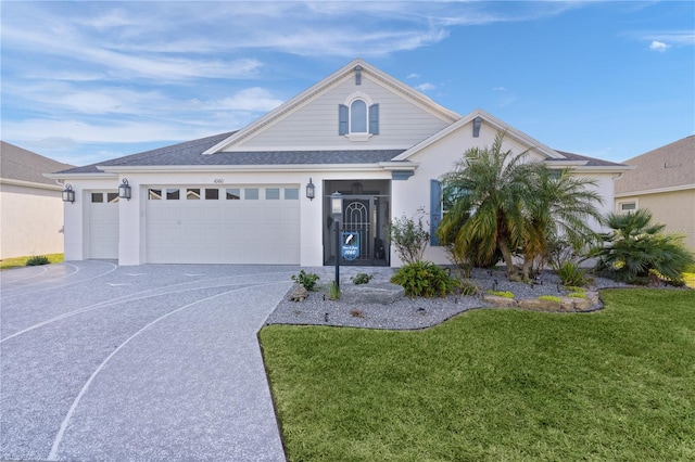 view of front of property with a garage and a front yard