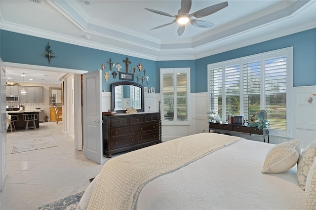 tiled bedroom featuring ceiling fan, crown molding, and a raised ceiling