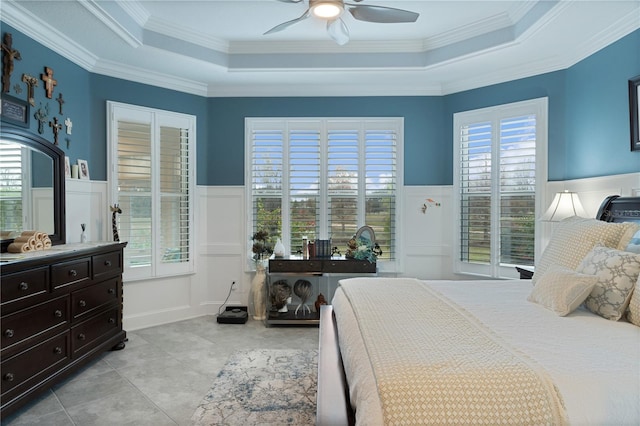 tiled bedroom with ceiling fan, crown molding, and a tray ceiling