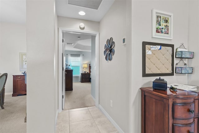 hall featuring light colored carpet