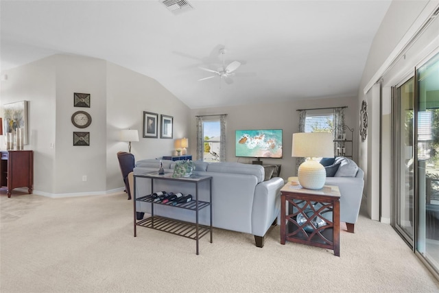 carpeted living room featuring plenty of natural light, lofted ceiling, and ceiling fan