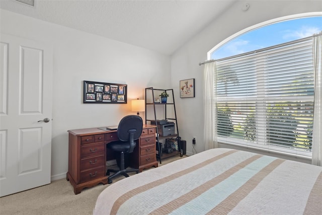 bedroom with light carpet and lofted ceiling