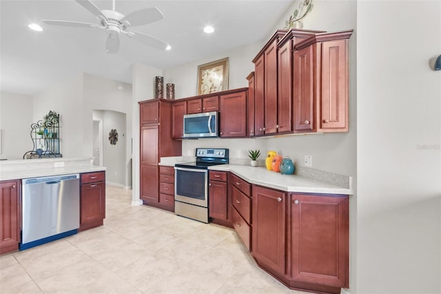 kitchen with ceiling fan, light tile patterned flooring, and stainless steel appliances