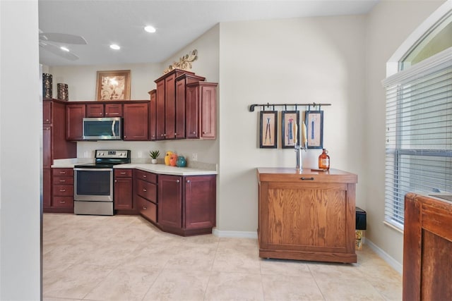 kitchen featuring ceiling fan and stainless steel appliances