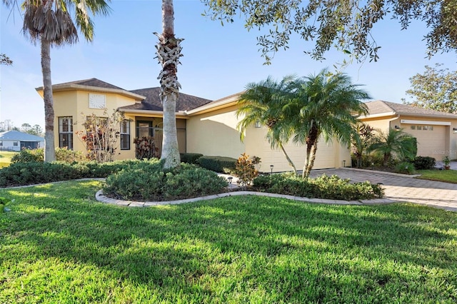 view of front of house with a garage and a front yard