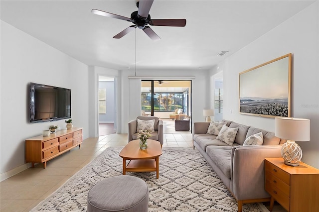 living room with ceiling fan and light tile patterned flooring