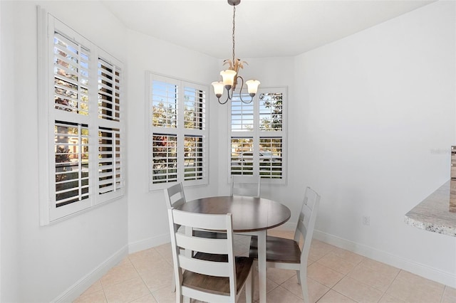 dining room featuring light tile patterned floors and a notable chandelier