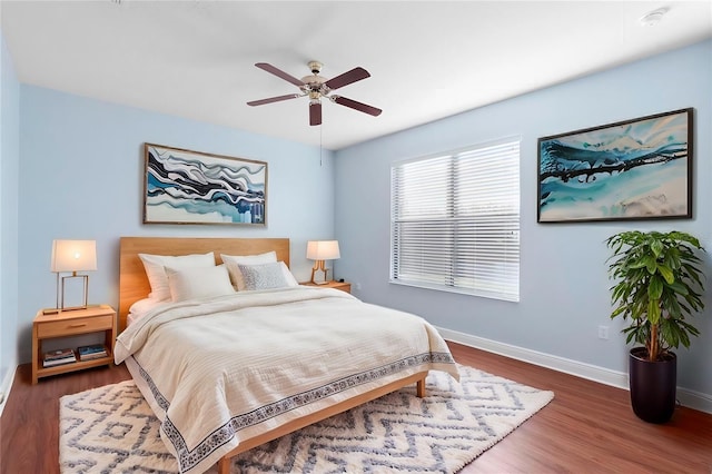 bedroom with ceiling fan and dark wood-type flooring