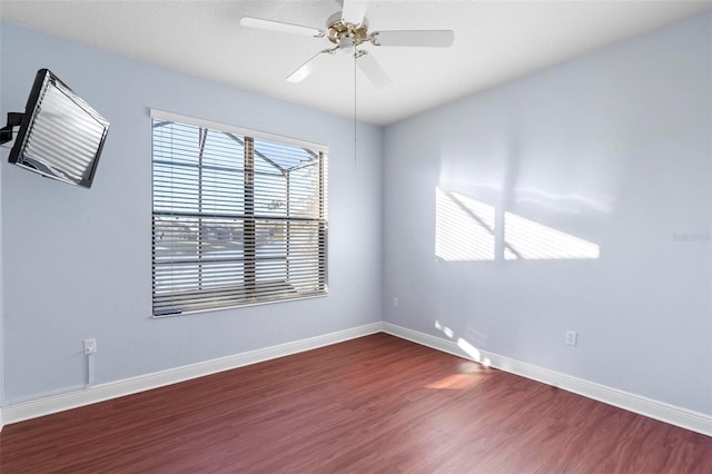 spare room featuring ceiling fan and dark hardwood / wood-style flooring