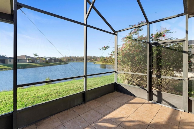 unfurnished sunroom with plenty of natural light and a water view