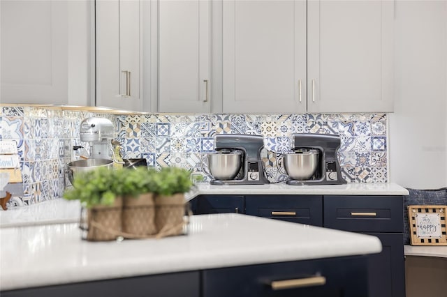 interior details featuring decorative backsplash and white cabinetry