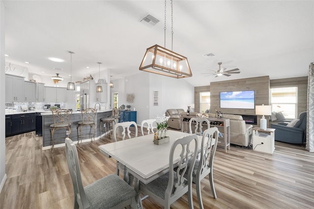 dining area with ceiling fan and light wood-type flooring