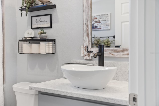 bathroom featuring toilet and vanity