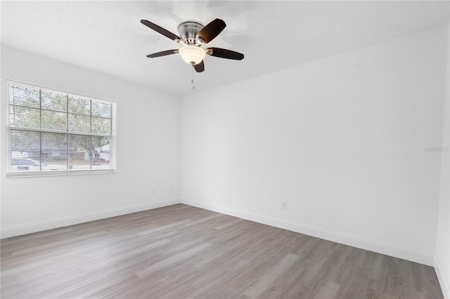 unfurnished room featuring light hardwood / wood-style floors and ceiling fan