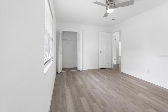 unfurnished bedroom with a closet, ceiling fan, and light hardwood / wood-style flooring