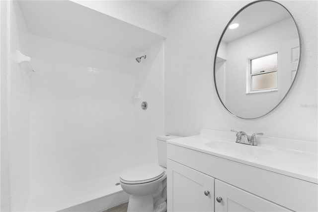 bathroom with vanity, toilet, and walk in shower