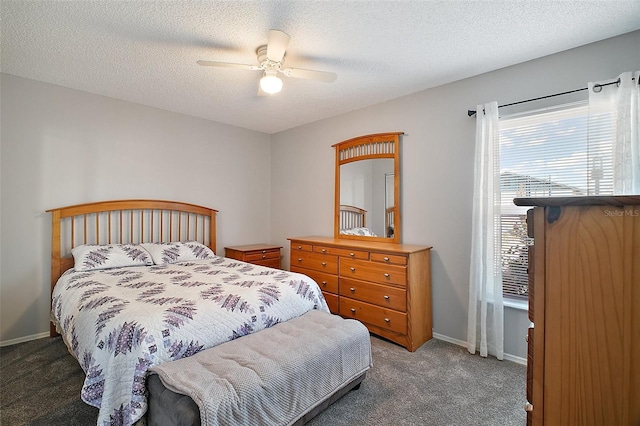 carpeted bedroom featuring a textured ceiling and ceiling fan