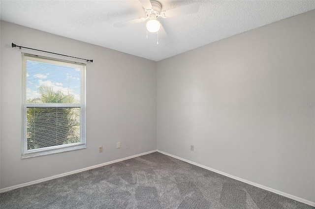 carpeted spare room featuring ceiling fan and a textured ceiling