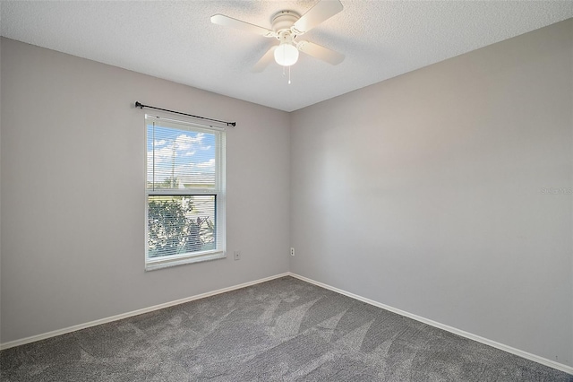 carpeted empty room with ceiling fan and a textured ceiling