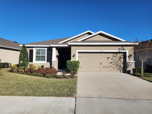 view of front facade featuring a front yard and a garage