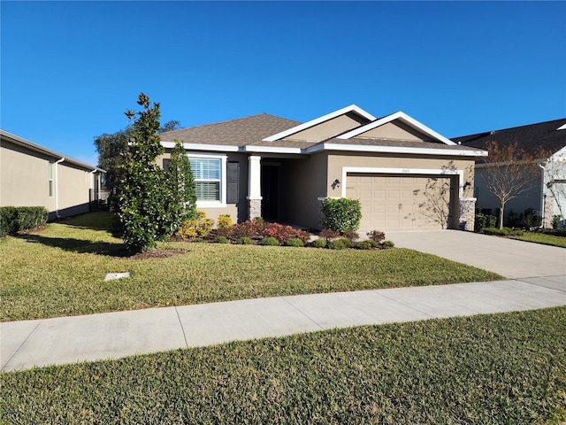 view of front of house featuring a front yard and a garage