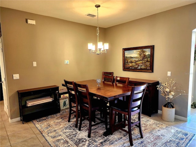 tiled dining area with a chandelier