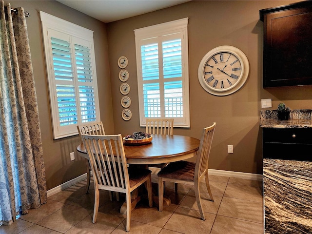 dining space featuring light tile patterned floors