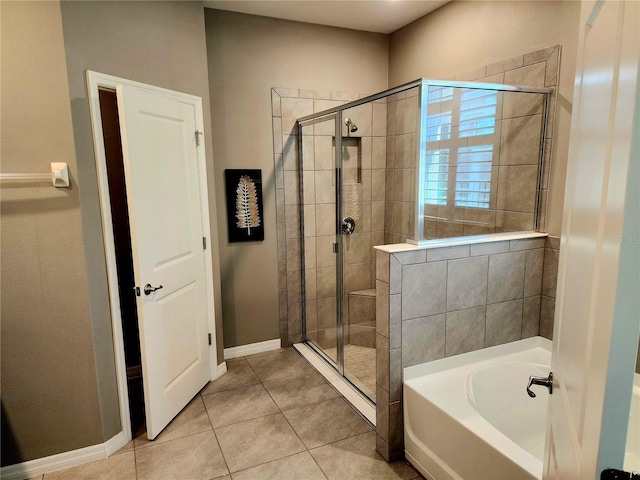 bathroom featuring tile patterned flooring and shower with separate bathtub