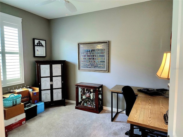 carpeted home office with plenty of natural light and ceiling fan