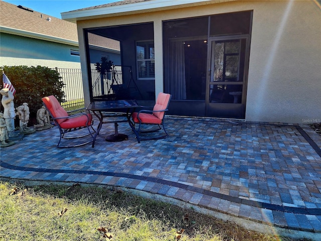 view of patio / terrace featuring a sunroom