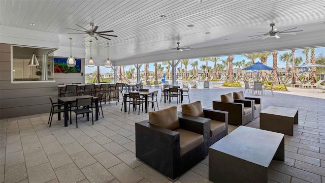 view of patio with an outdoor living space, exterior bar, and a pool