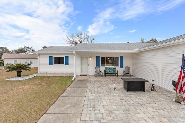 exterior space featuring a patio area and a front lawn