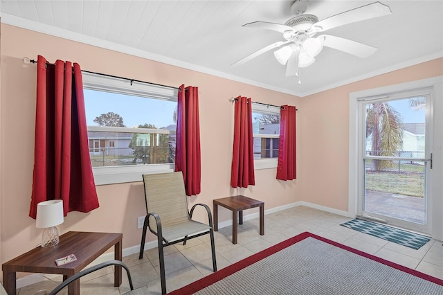 living area with ceiling fan, light tile patterned flooring, and ornamental molding