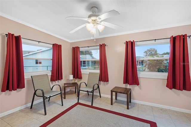 living area with ceiling fan and light tile patterned floors