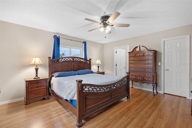 bedroom with ceiling fan, a textured ceiling, and light wood-type flooring