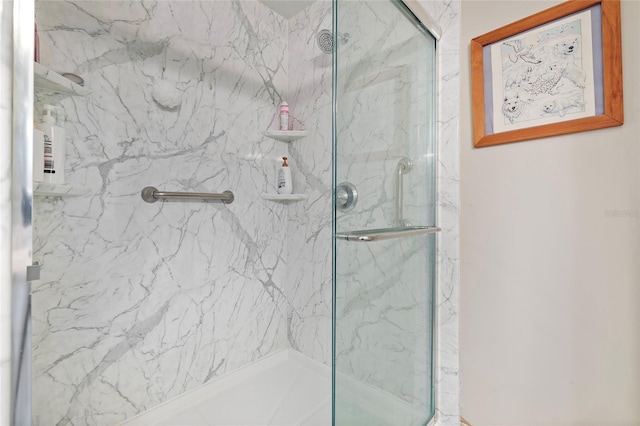 bathroom with a shower with shower door