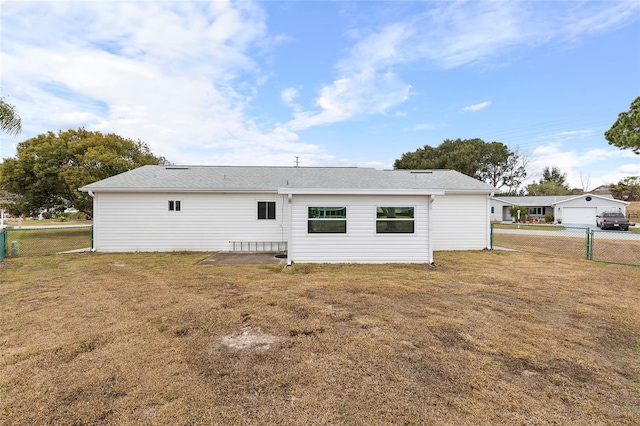 back of property featuring a yard