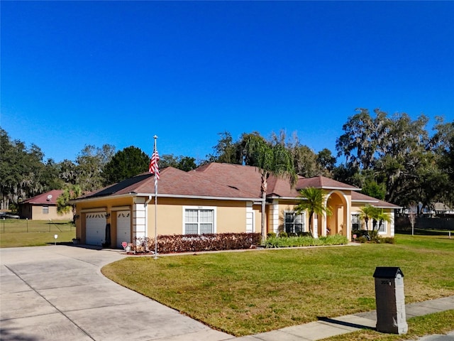 ranch-style home featuring a garage and a front yard