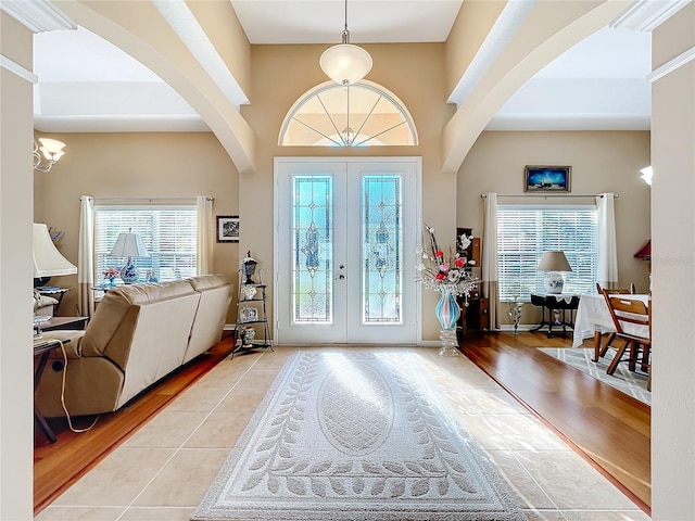 tiled foyer entrance featuring french doors and a healthy amount of sunlight