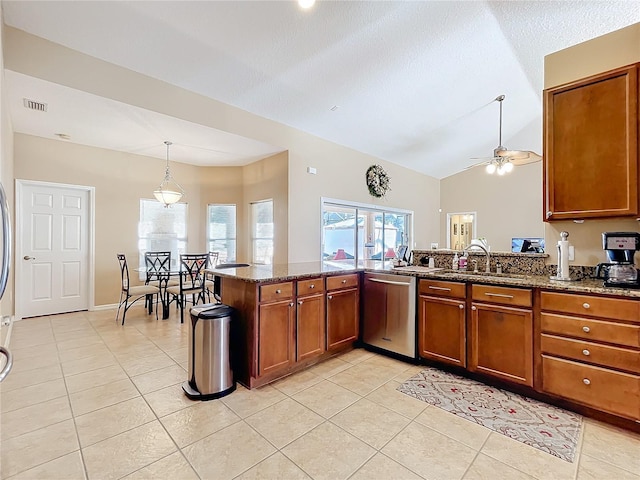 kitchen with ceiling fan, sink, stainless steel dishwasher, kitchen peninsula, and dark stone countertops