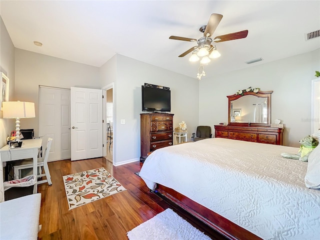 bedroom with ceiling fan and dark hardwood / wood-style floors