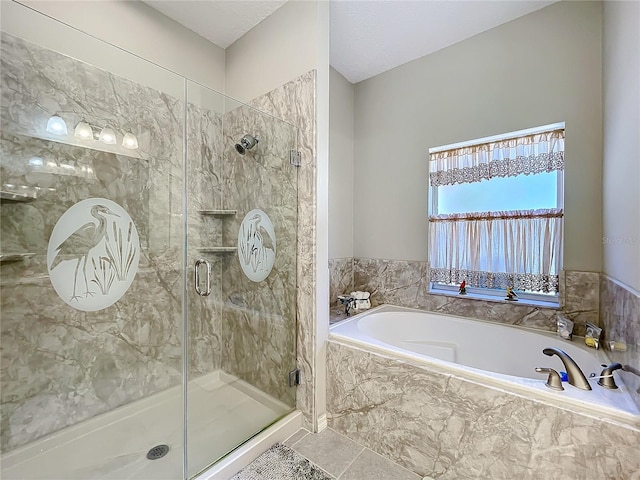 bathroom featuring tile patterned floors and independent shower and bath